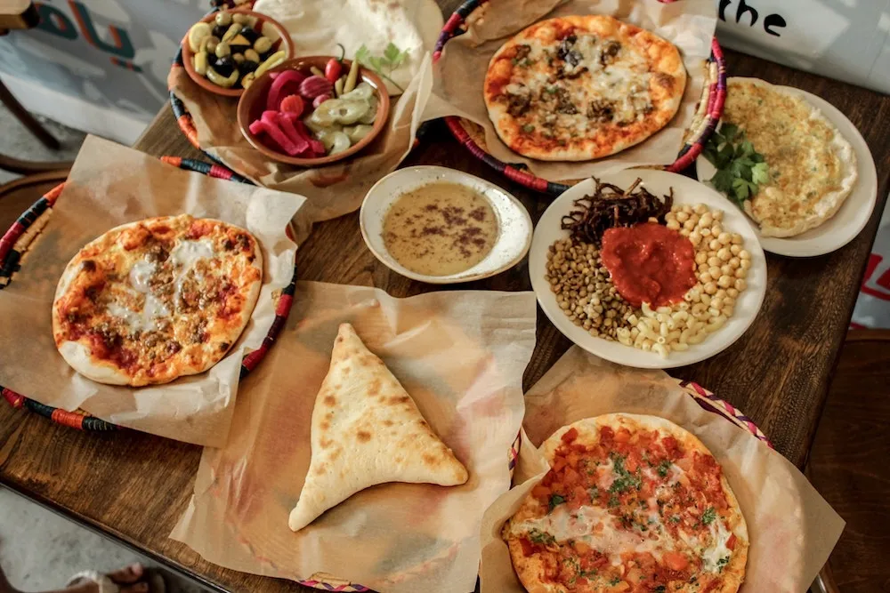 Manakeesh, pickles, hummus and foul boxed fresh at Yafa Café on Portage Avenue for Winnipeg Palestinian takeout orders